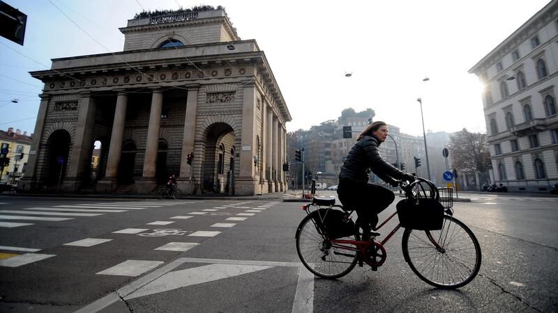 A cyclist rides through the Porta Venezia area of Milan in Italy where travelling by car will be banned for parts of the next three days in an attempt to lessen smog brought about by the absence of wind and rain. Photograph: Daniele Mascolo/EPA.