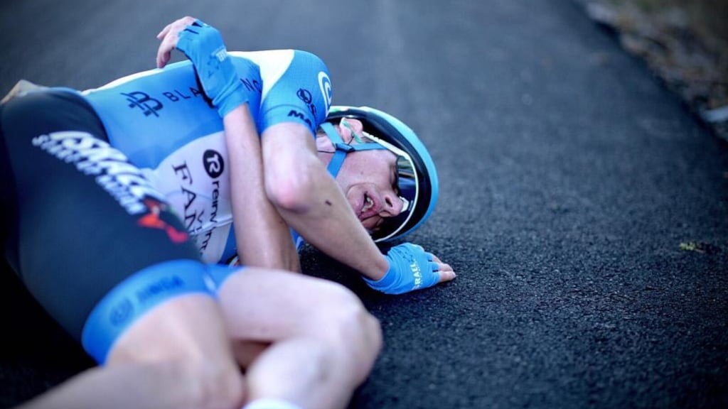Dan Martin lies on the road after crossing the finishing line at Alto de Moncalvillo after stage 8 of the  Vuelta a España. Photograph: Noa Arnon