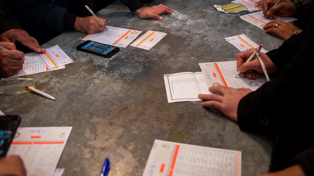 Voters fill in their ballot papers during the general election in Tehran, Iran, on Friday. Photograph: Ali Mohammadi/Bloomberg
