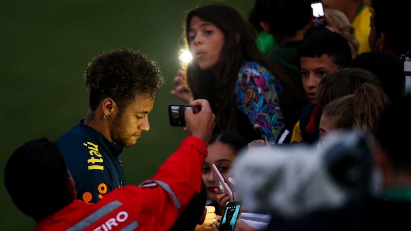 Neymar signs autographs for supporters after a training session at the Brazil’s Granja Comary training complex in May 2018 in Teresopolis, Brazil. Photograph: Buda Mendes/Getty Images