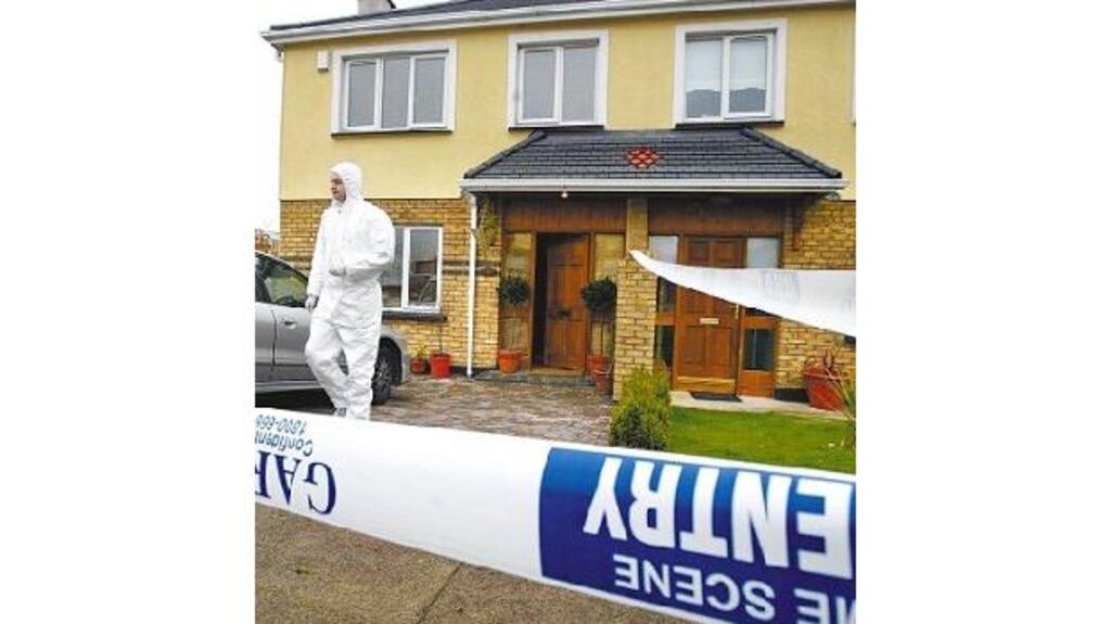A garda at the house in Tallaght where a family and babysitter were threatened by armed men who then stole a quantity of cash and a van.