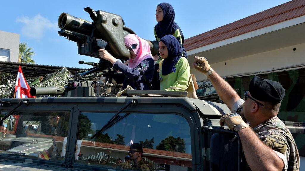 Lebanese girls look at an anti-armour TOW2 rocket mounted on a Lebanese vehicle during an open day between the Lebanese army and UN peacekeeping troops in the southern port city of Tyre, Lebanon. Photograph: Wael Hamzeh