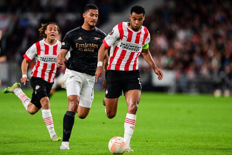 Arsenal's French defender William Saliba fights for the ball with PSV's Dutch forward Cody Gakpo. Photograph: Olaf Kraak/ANP/AFP via Getty