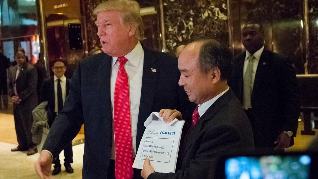 US president-elect Donald Trump and Son Masayoshi, CEO of SoftBank, meet the press following a meeting at Trump Tower in New York. Photograph: Albin Lohr-Jones/EPA