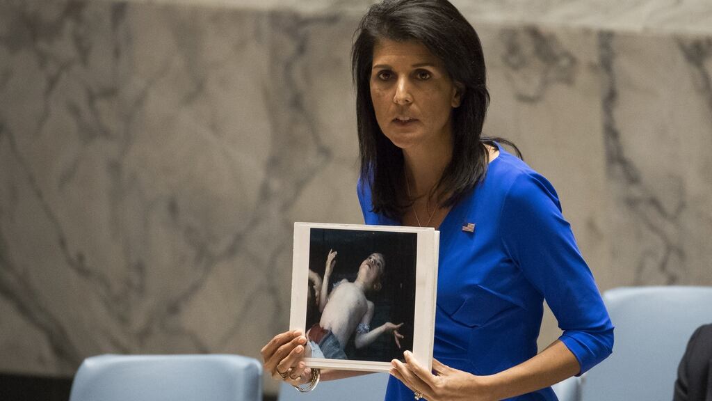 US ambassador to the UN Nikki Haley holds a photo of a victim of the Syrian chemical attack at a meeting of the  Security Council. Photograph: Drew Angerer/Getty Images