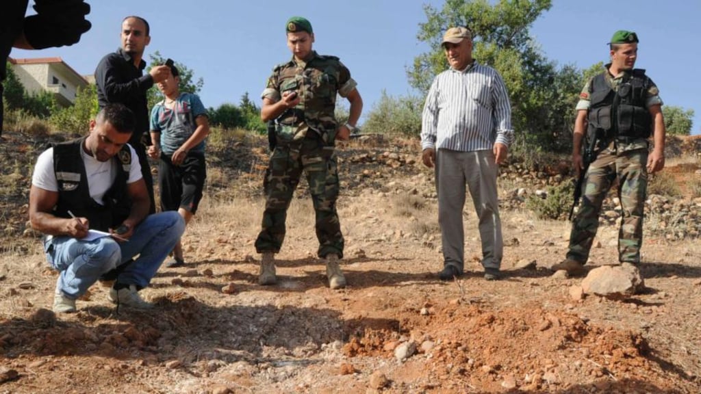 Lebanese soldiers inspect a site in the town of Seriine in the Bekaa valley that was hit by a rocket residents say was fired from Syria. Photograph: Reuters