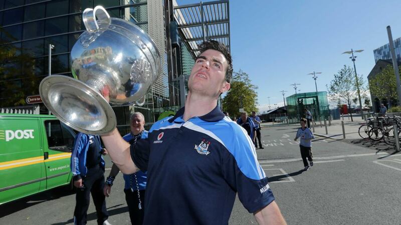 Michael Darragh Macauley holding the  the Sam Maguire cup. Photograph: Morgan Treacy/Inpho