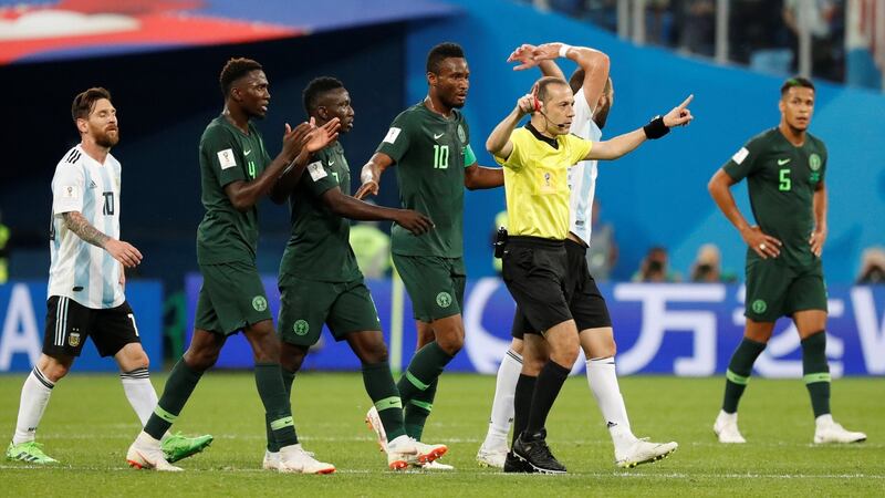 Referee Cuneyt Cakir gestures a referral to VAR during the Argentina v Nigeria match. Photo: Toru Hanai/Reuters