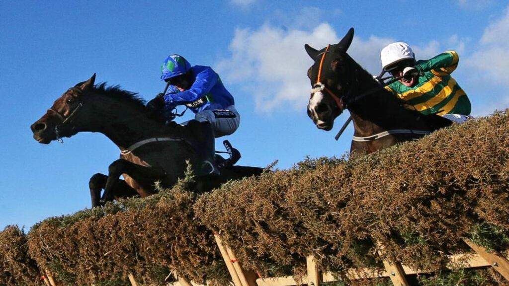 Ruby Walsh, left, onboard Hurricane Fly clears the last hurdle ahead of Tony McCoy onboard Jezki. Photograph: Cathal Noonan/Inpho
