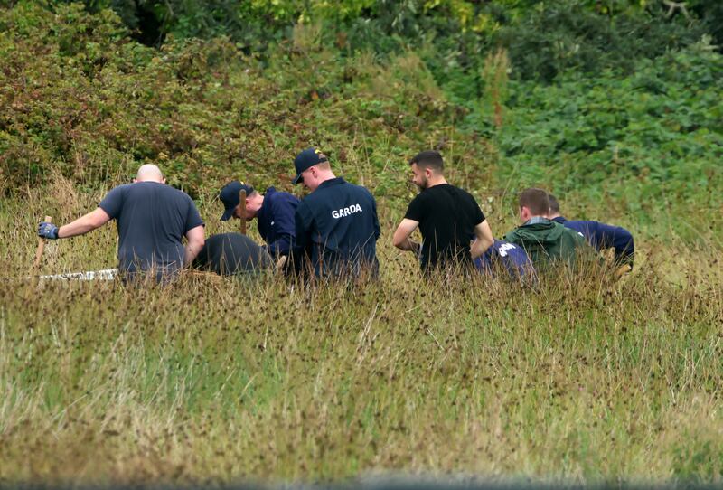 Gardaí on Wednesday at an area of open ground on the Portrane Road, Donabate, where they are continuing their search for a child, feared dead. Photograph: Colin Keegan/Collins Dublin