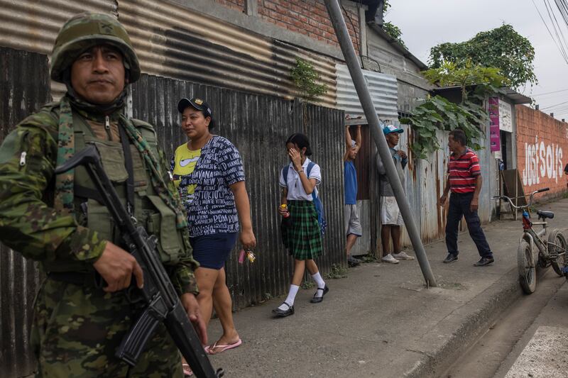 A soldier on patrol near a school in Guayaquil, Ecuador, where local groups linked to drug trafficking often recruit children to become gang members and have sent threatening pamphlets to schools. Photograph: Victor Moriyama/The New York Times