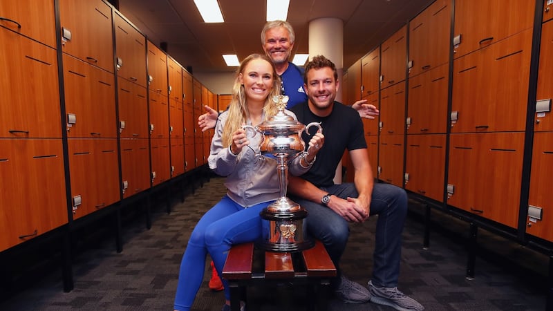 Caroline Wozniacki poses with the Daphne Akhurst Trophy with fiance David Lee and father Piotr in the lockerroom after winning the women’s singles final. Photograph: Clive Brunskill/Getty Images