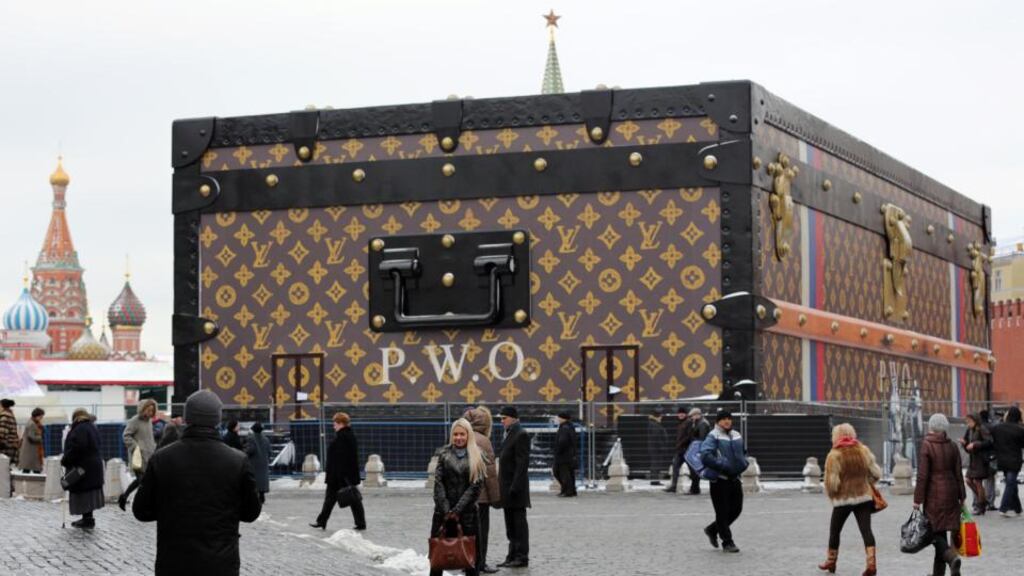 People pass a huge Louis Vuitton trunk on Red Square in Moscow – the giant trunk measures nine meters high and 30 meters long and decorated with the brand’s logo. Photograph: Andrey Rudakov/Bloomberg