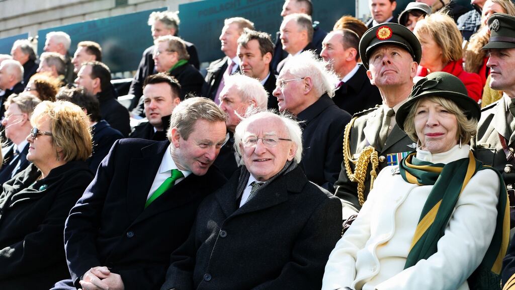 Acting Taoiseach Enda Kenny chats to President Michael D Higgins at the Easter Sunday commemoration ceremony and parade from O’Connell Street, Dublin. Photograph: Maxwells