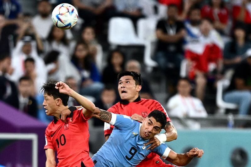 Uruguay's Luis Suarez fights for the ball with South Korea's Jae-sung Lee and Min-jae Kim. Photograph: Jewel Samad/AFP via Getty Images