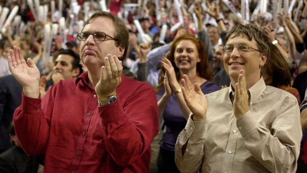 Microsoft co-founder Paul Allen (left), who died this week aged 65, is pictured with Bill Gates cheering his basketball team the Portland Trail Blazers in 2000. Photograph: File photograph: Reuters