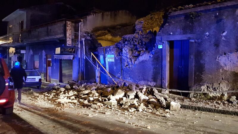 Firemen work in the ruins of a house after an earthquake hit the village of Fleri, Catania district, Italy, early on December 26th. Photograph: EPA