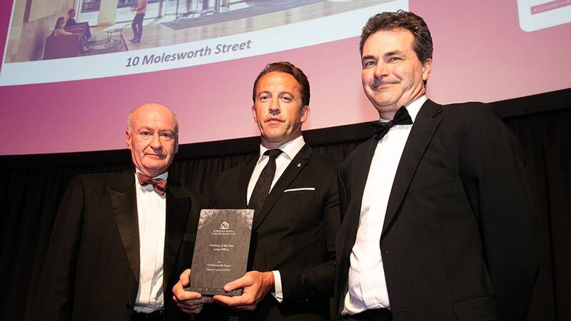 Aaron O'Grady, Managing Director, Vision Creative Studios presents the Building of the Year Large Office award to Paul O’Brien & Ronan Savage, Henry J Lyons.