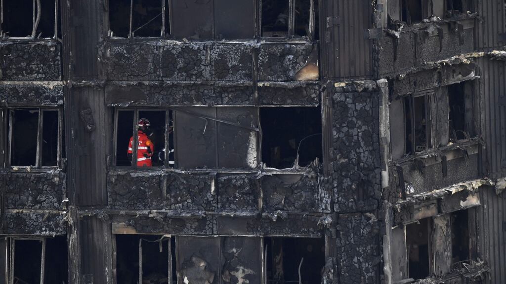 Emergency workers and police inspect inside the remains of Grenfell Tower in west London. Photograph: Chris J Ratcliffe/AFP/Getty Images