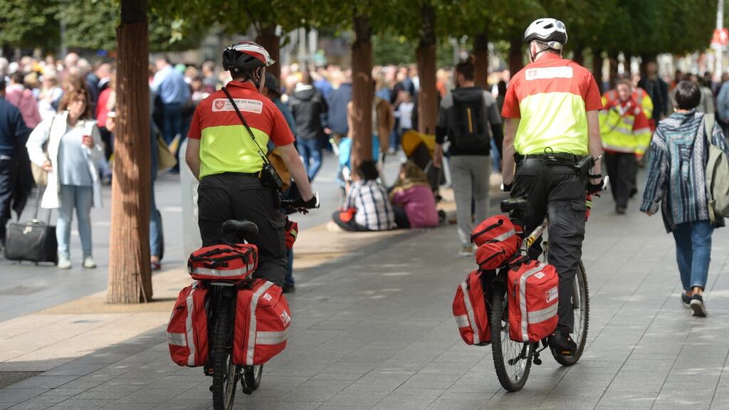Order of Malta on bikes as they wait on Pope Francis to pass through O’Connell Street, Dublin. Photograph: Dara Mac Dónaill