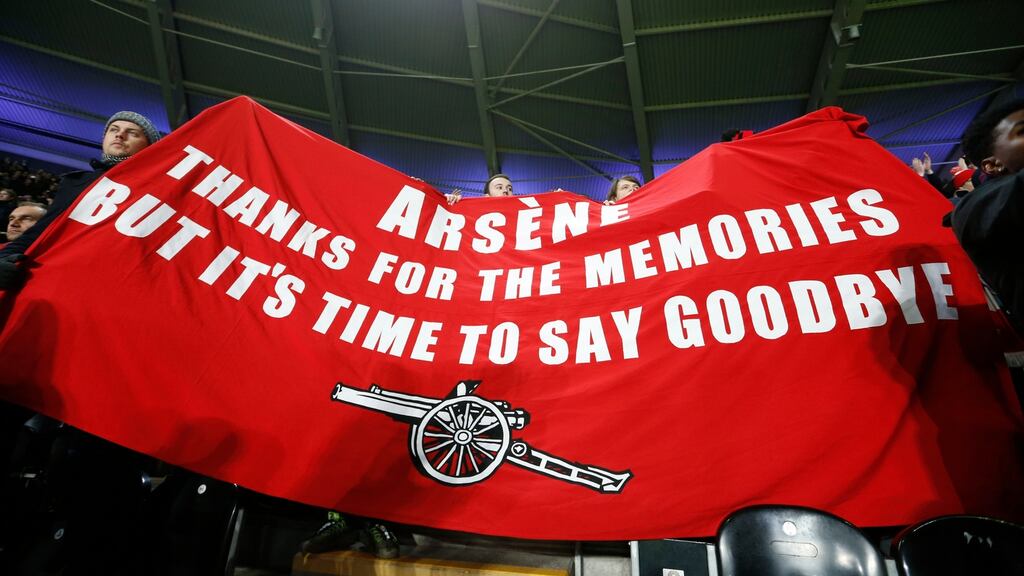 Arsenal fans with a banner directed at manager Arsene Wenger during the victory over Hull City. Photograph: Carl Recine/Reuters