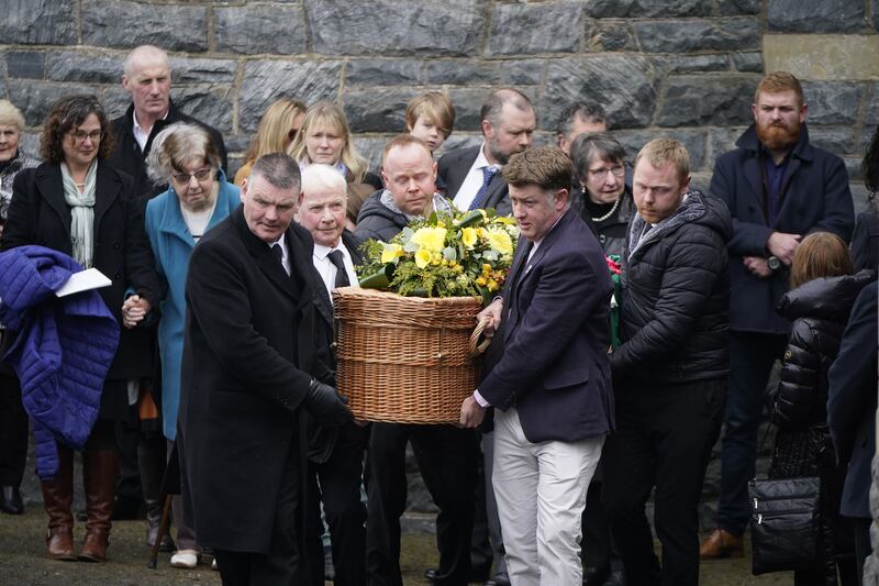 The coffins of Una Bowden and her daughters Ciara and Saoirse are moved from the church. Photograph: Niall Carson/PA Wire
