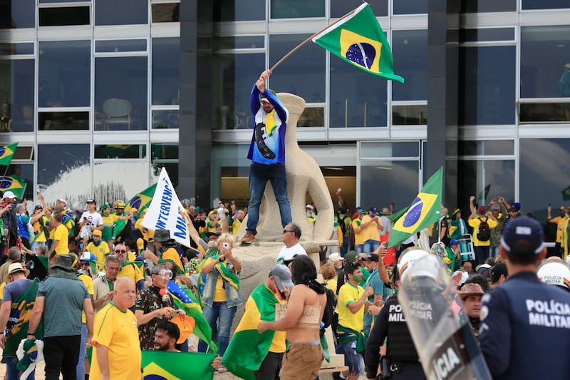 Supporters of Brazil's former president Jair Bolsonaro invade Planalto Presidential Palace while clashing with security forces. Photograph: Sergio Lima/AFP via Getty Images