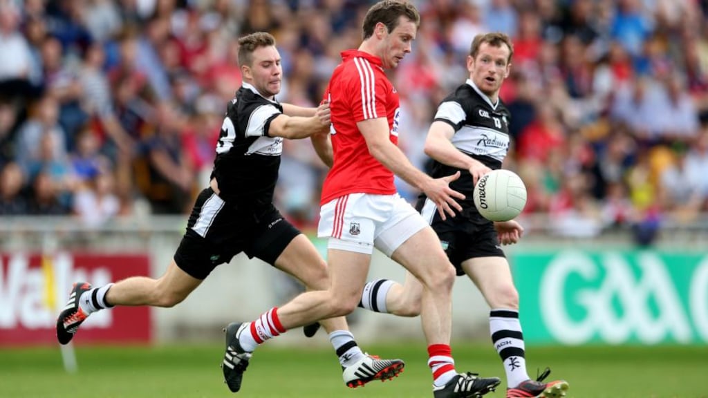 Sligo’s Stephen Coen and Mark Breheny track Cork’s James Loughrey in Tullamore. Photograph: James Crombie / Inpho