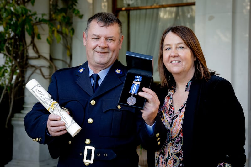 Garda Kieran Donovan, with his wife Breda, received a bronze medal for saving a man in distress from a motorway bridge. Photograph: Maxwells
