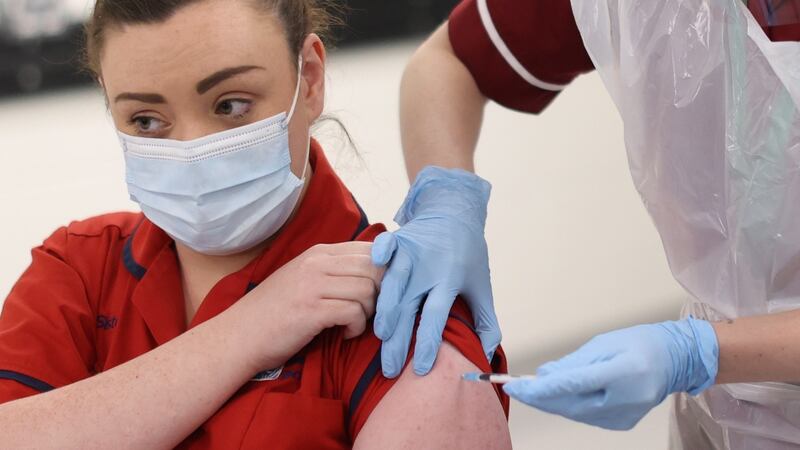 Joanna Sloan becomes the first person in Northern Ireland to receive the first of two Pfizer/BioNTech Covid-19 vaccine jabs, at the Royal Victoria Hospital, in Belfast. Photograph: Liam McBurney/PA Wire