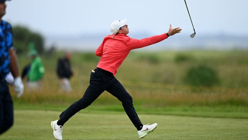 Rory McIlroy fails to catch his club after throwing it in the air on the 15th fairway during his first round. Photograph:  Glyn Kirk/AFP via Getty Images