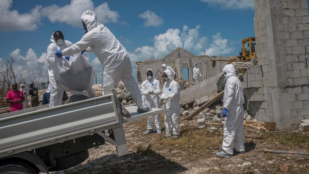 A forensics team removes three bodies recovered form a collapsed church in the Pigeon Peas neighbourhood of Marsh Harbour, Bahamas, on Saturday. Photograph: Daniele Volpe/The New York Times
