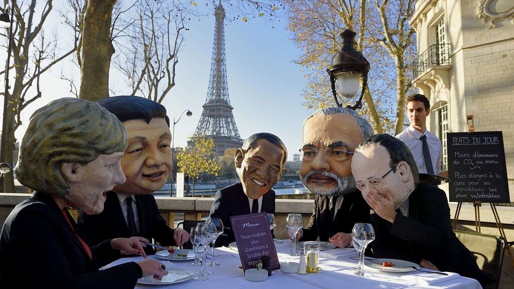 Performers wearing effigies of world leaders (From L) German chancellor Angela Merkel, China’s president Xi Jinping, US president Barack Obama, Indian prime minister Narendra Modi and French president Francois Hollande gather for a breakfast organized by Oxfam NGO in Paris, on the eve of the COP21 United Nations conference on climate change. Photograph: Eric Feferberg/ AFP/Getty Images