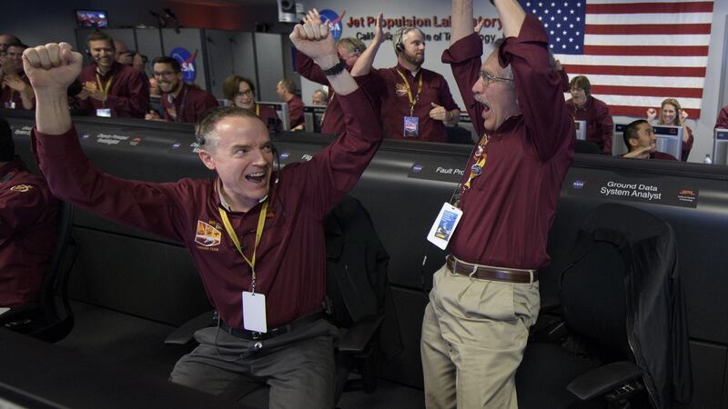 Mars InSight team members Kris Bruvold (L) and Sandy Krasner react after receiving confirmation that the Mars InSight lander successfully touched down on the surface of Mars. Photograph: Bill Ingalls/NASA via Getty Images