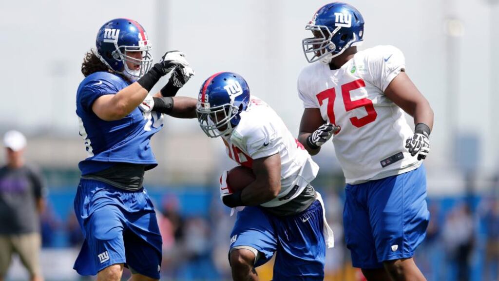 New York Giants running back Michael Cox (29), centre, and linebacker Kyle Bosworth (48) keep from heavy contact during the Giant’s training camp in East Rutherford, NJ. Photograph: Demetrius Freeman/The New York Times