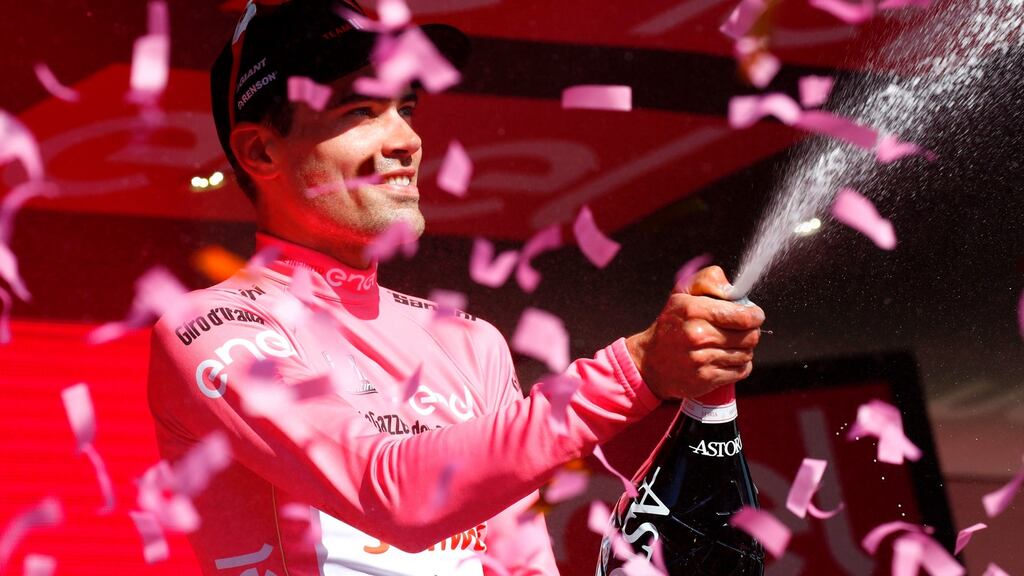 Dutch cyclist Tom Dumoulin from Team Sunweb sprays champagne as he celebrates on the podium after winning the 10th stage from Foligno to Montefalco during the 100th Giro d’Italia. Photo: Luk Benies/Getty Images