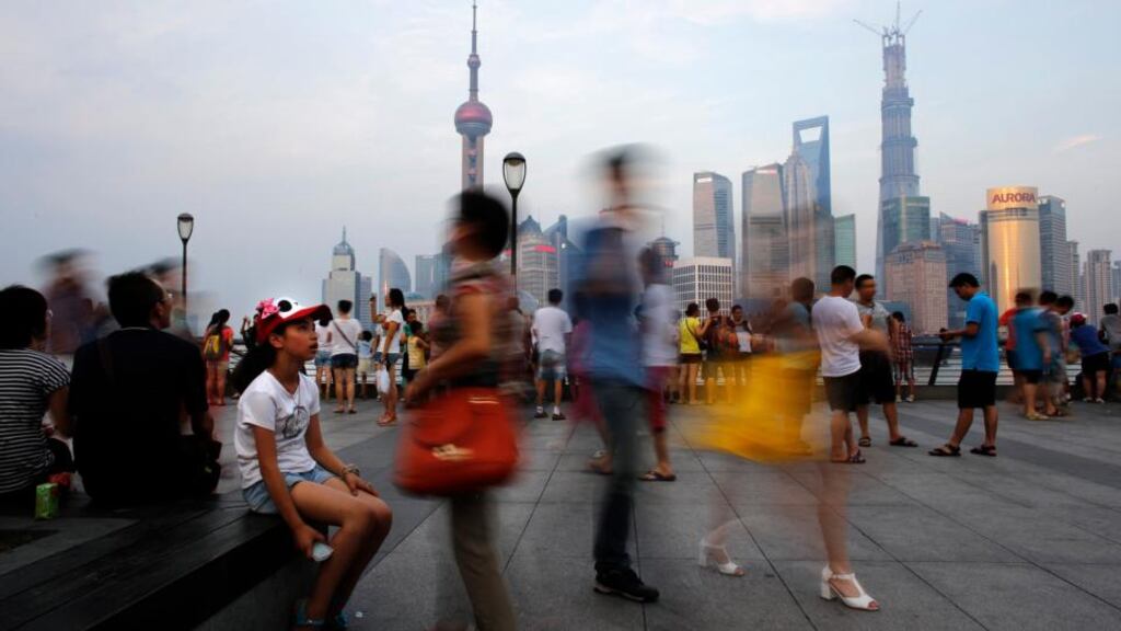 People walk along the Bund in front of the financial district of Pudong, in downtown Shanghai. The nightmare scenario for China’s leaders as they try to wean the country off a diet of easy credit and breakneck expansion is a local government buckling under the weight of its own debt. Photograph: Carlos Baria/Reuters
