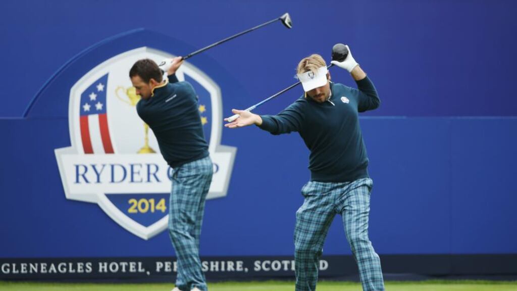 Victor Dubuisson and Graeme McDowell of Europe warm up on the first tee during practice ahead of the 2014 Ryder Cup on the PGA Centenary course at Gleneagles in Auchterarder, Scotland. Photo: Ross Kinnaird/Getty Images