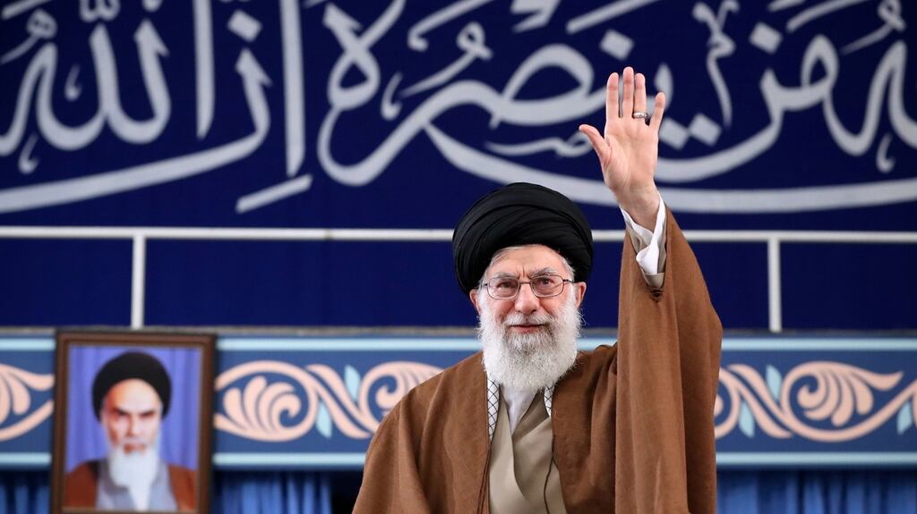 Iranian supreme leader Ayatollah Ali Khamenei greeting the crowd during a meeting with Iranian students in Tehran, Iran, today. Behind him is a portrait of his predecessor, Ayatollah Ruhollah Khomeini, founder of Iran as an Islamic Republic. Khamenei has held the position of supreme leader for almost 30 years. Photograph: Handout/EPA