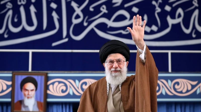 Iranian supreme leader Ayatollah Ali Khamenei greeting the crowd during a meeting with Iranian students in Tehran, Iran, today. Behind him is a portrait of his predecessor, Ayatollah Ruhollah Khomeini, founder of Iran as an Islamic Republic. Khamenei has held the position of supreme leader for almost 30 years. Photograph: Handout/EPA