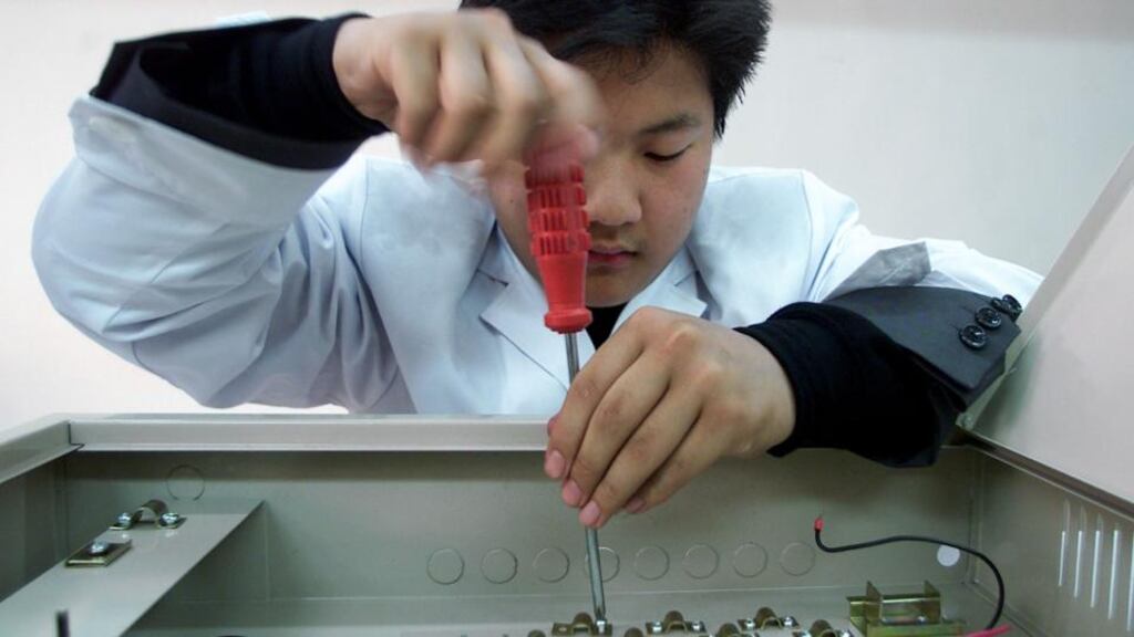 A Chinese man works at Yanxiang Electronic Science and Technology, a private enterprise in the northern city of Tianjin. Photograph: Guang Niu/Reuters