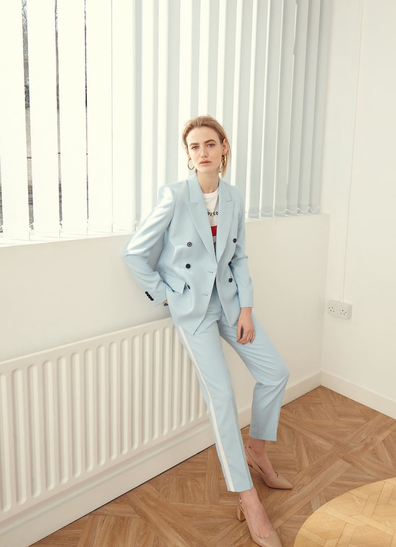 Powder blue jacket €330, trousers €200 both by Calvin Klein, t-shirt €55 by Set, shoes €130 Kurt Geiger, earrings €198 Thomas Sabo, Whitemeadow coffee table €499