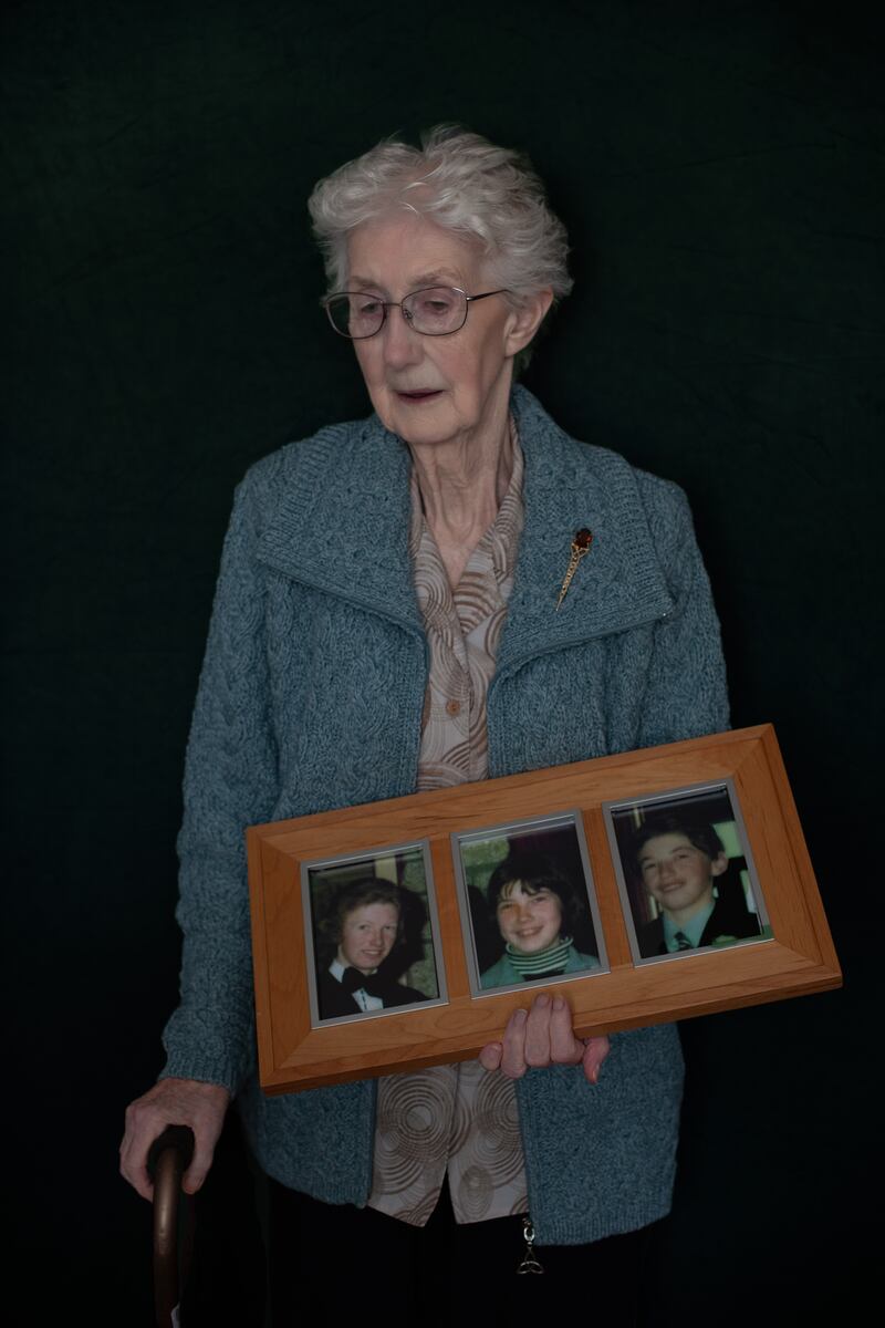 This is Bridget McDermott with photos of her three children. Photograph: Deirdre Brennan