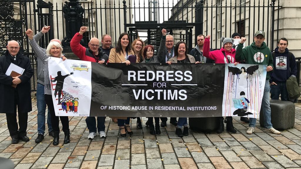 Survivors of historical institutional abuse celebrate outside The Court of Appeal in Belfast, which ruled that the Executive Office has the power to introduce a compensation scheme for victims of historical institutional abuse. Photograph: Rebecca Black/PA Wire.