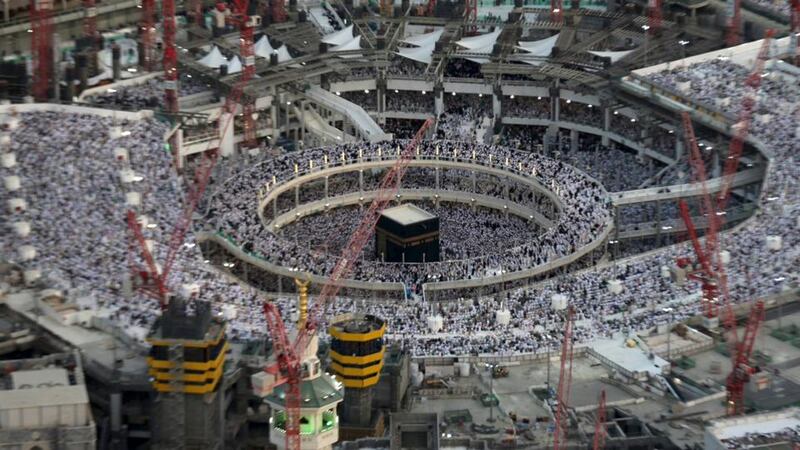 An aerial view shows Muslim worshippers praying at the Grand Mosque, Mecca, surrounded by construction cranes, in July. Photograph: Ali Al Qarni/Reuters