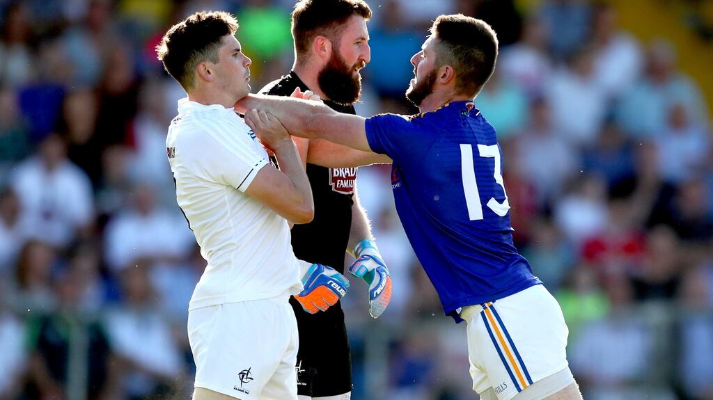 Kildare’s David Hyland and goalkeeper Mark Donnellan clash with Robbie Smyth of Longford. Photograph: James Crombie/Inpho