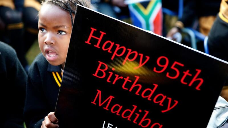 Children hold placards as they gather to wish the former president a happy birthday. Photograph: Mike Hutchings/Reuters