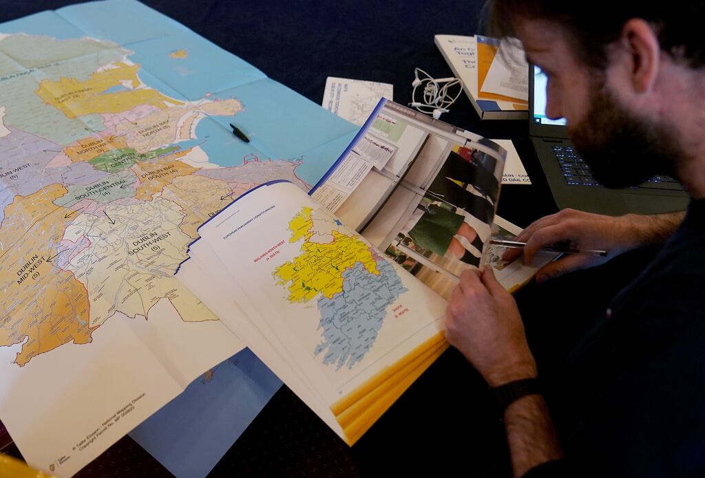 A journalist looks at a map of Ireland showing European Parliament constituencies as the Electoral Commission announced new constituency boundaries for Ireland, which has recommended the number of TDs increase from 160 to 174. Photograph: Brian Lawless/PA Wire