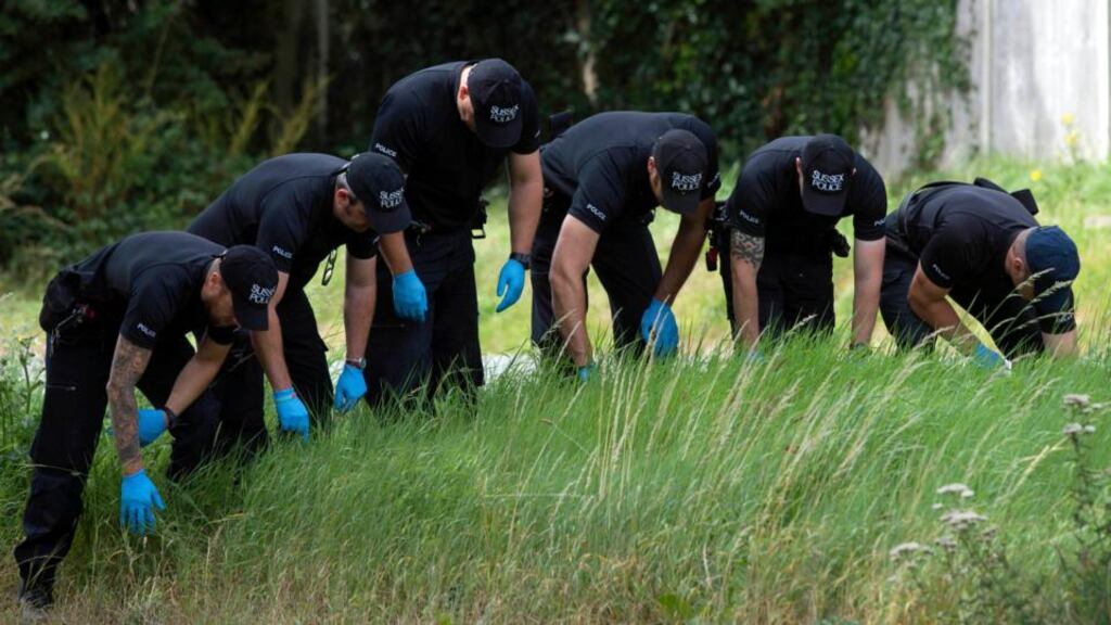 Police officers search the scene close to where pensioner Donald Lock was stabbed to death by another motorist in Findon, West Sussex, following a crash. Photograph: Hannah McKay/PA Wire.