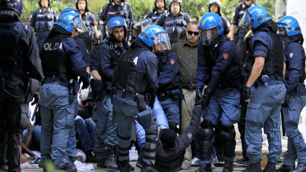 Italian police officers carry away a migrant from the Italian-French border in the city of Ventimiglia. Photograph: Jean Christophe Magnenet/AFP/Getty Images